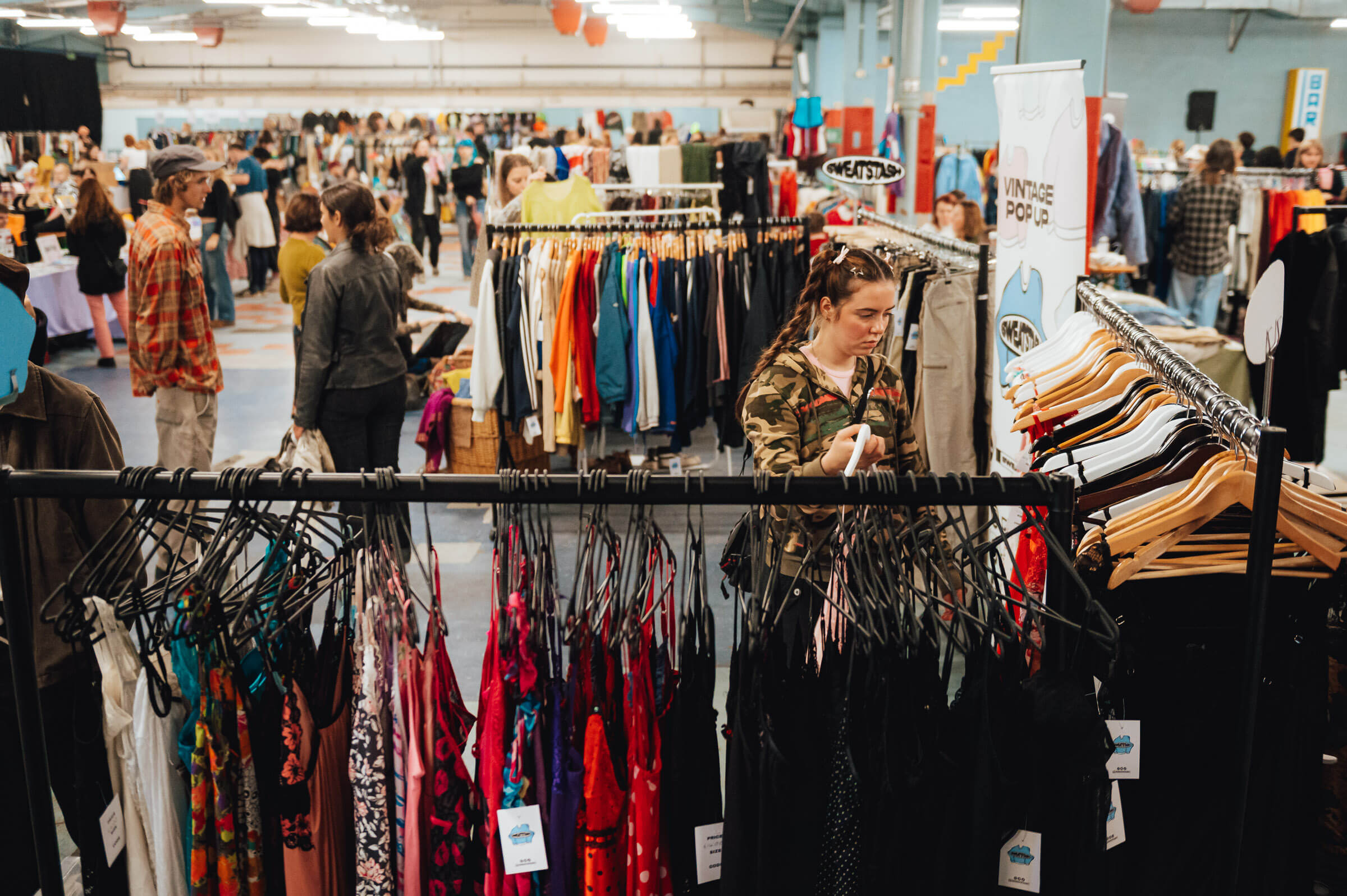 Bustling marketplace event at Document Bristol with diverse clothing racks.