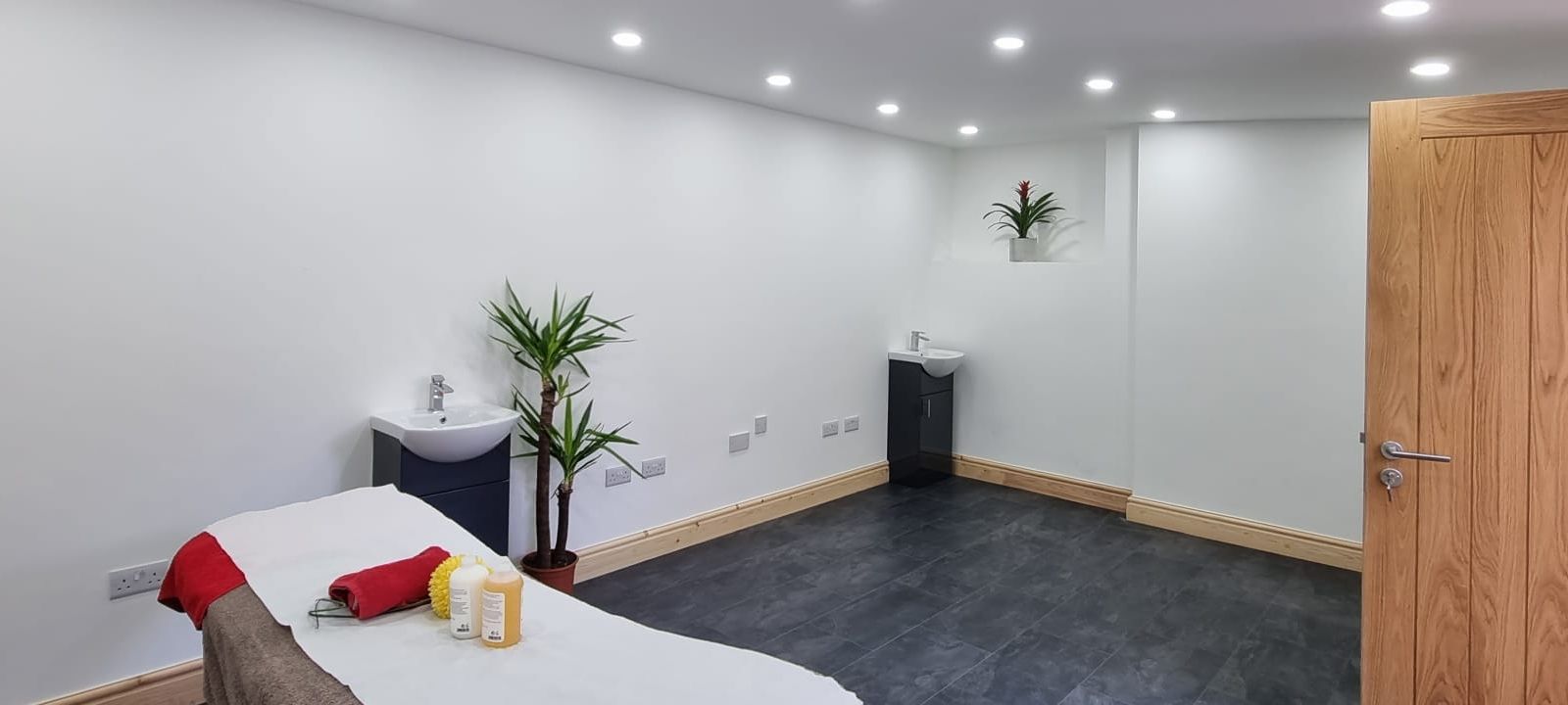 Minimalist treatment room with soft lighting for wellness events and workshops.