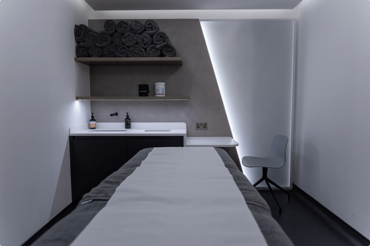 Sleek treatment room at One Aesthetics Clinic for spa services and wellness retreats.