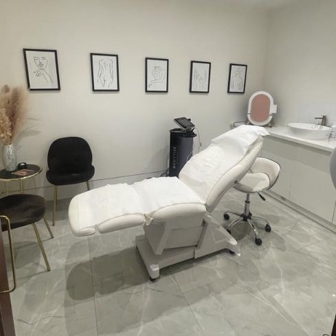 Treatment room with adjustable chair for wellness events and corporate retreats.