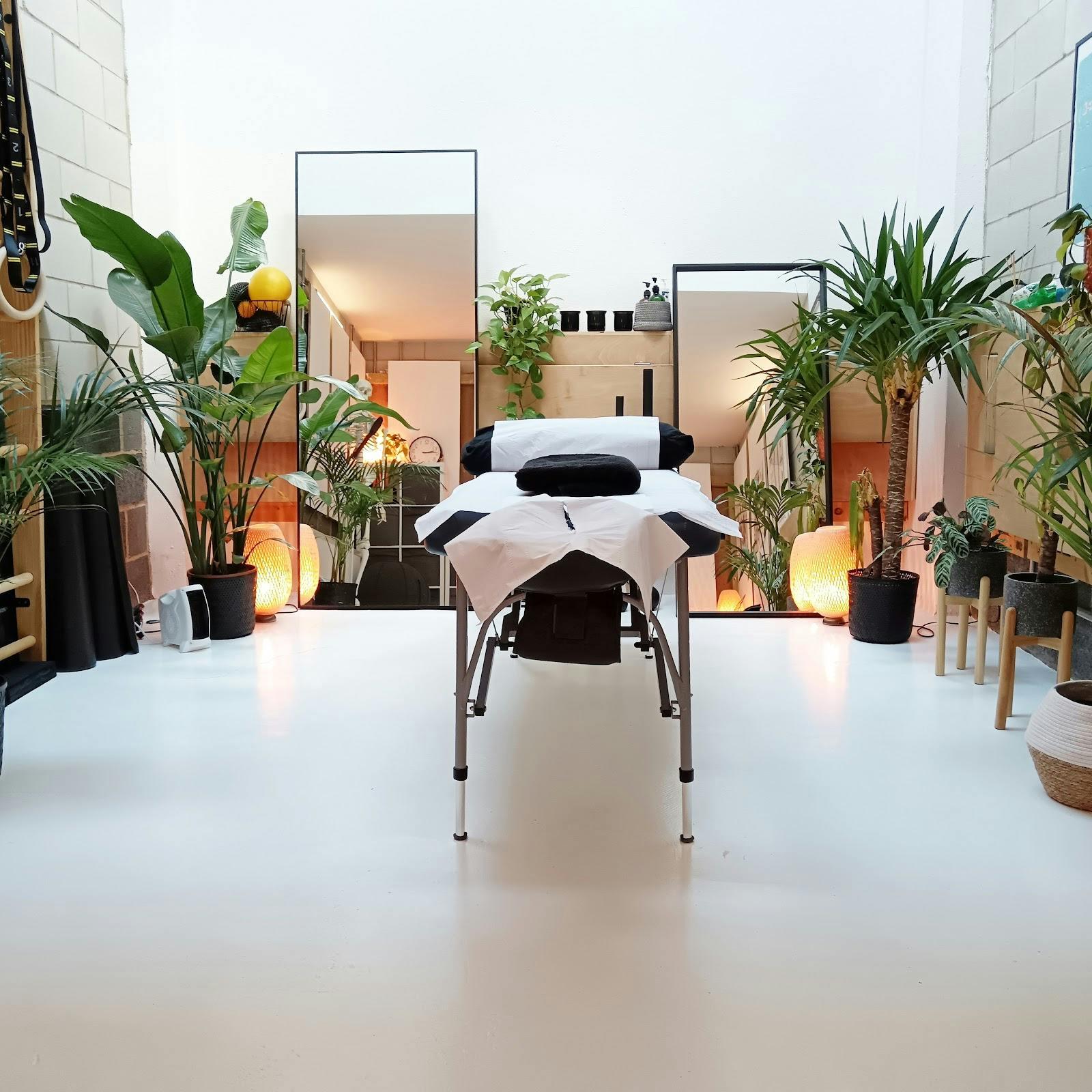 Serene wellness treatment room with massage table for retreats and stress relief events.