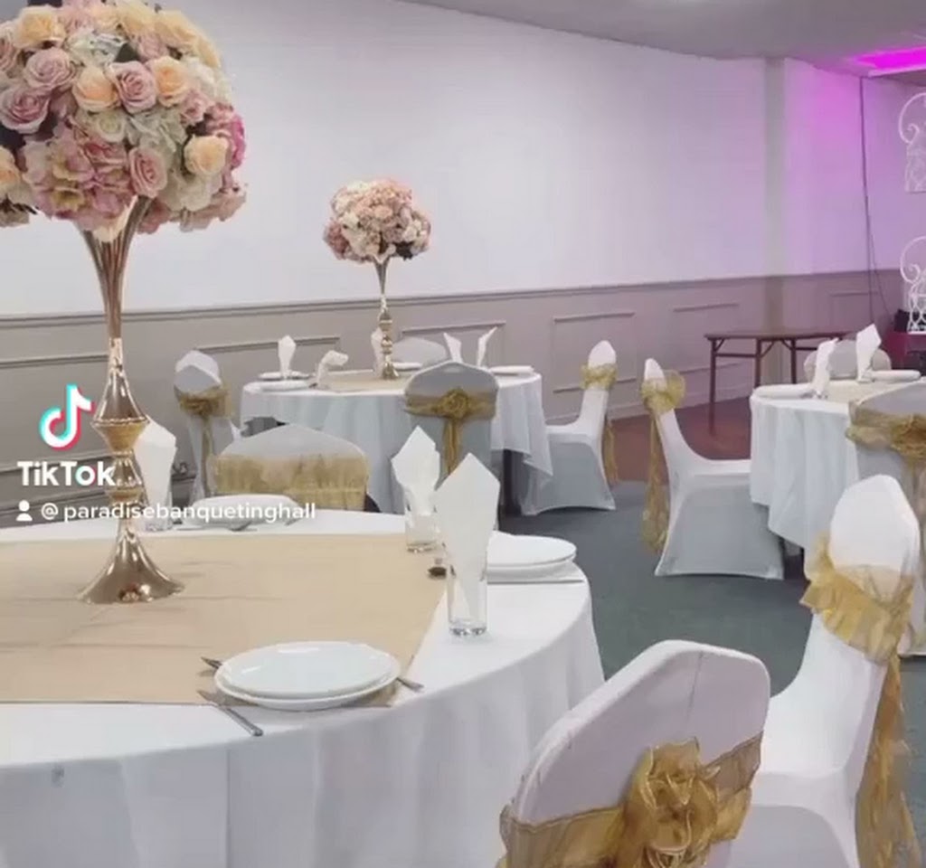 Elegant banquet hall with white tables and gold accents, perfect for weddings and events.