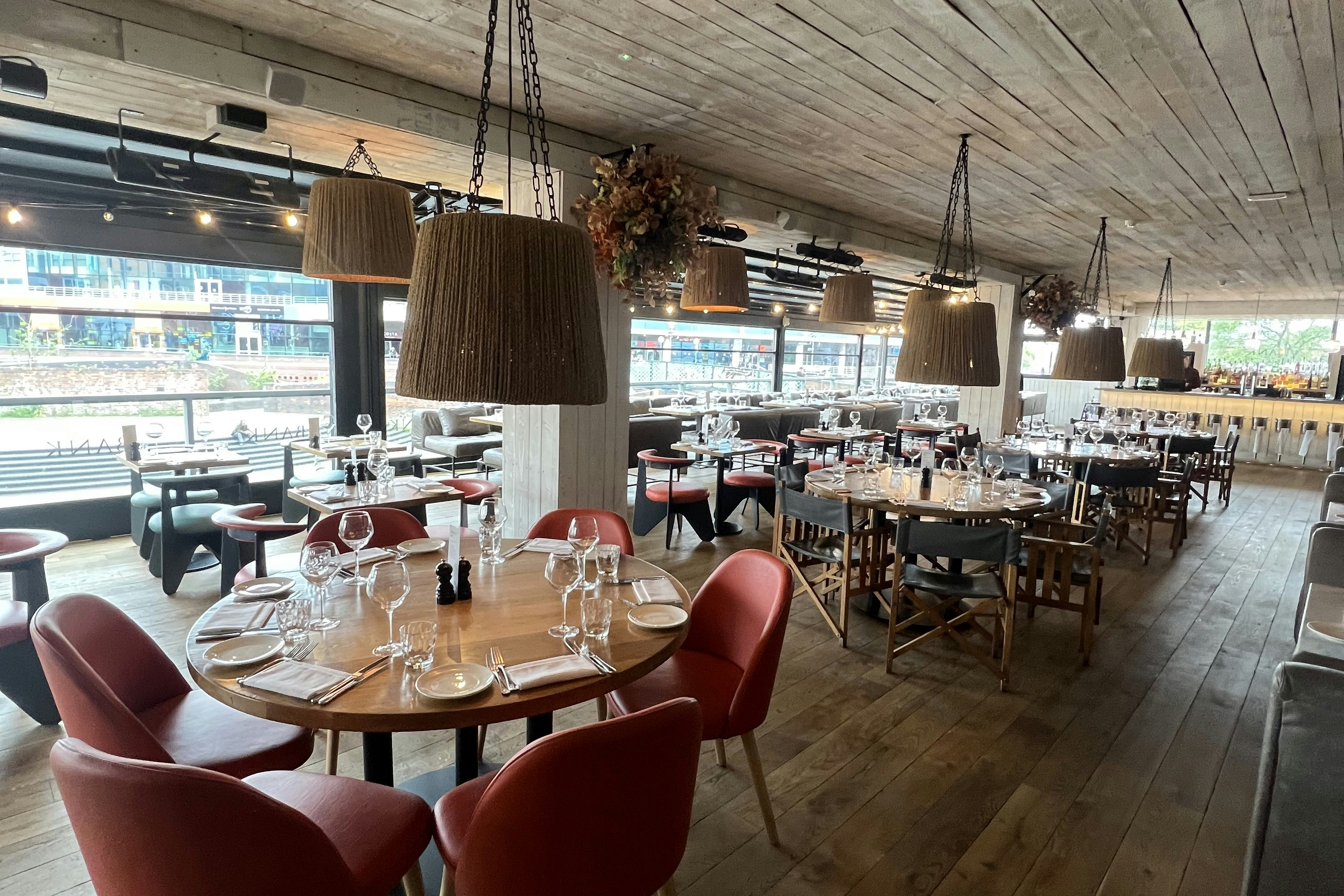 Stylish restaurant interior with waterfront view, ideal for events and gatherings.
