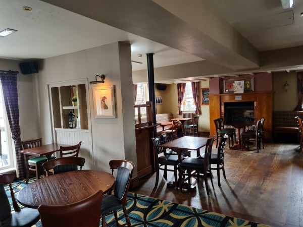 Cozy restaurant venue with wooden tables, perfect for intimate gatherings and meetings.