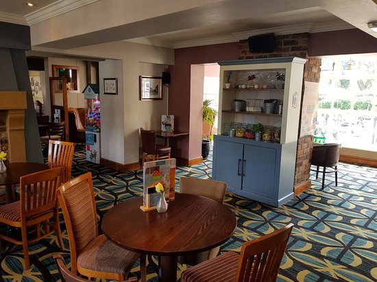Cozy meeting space with wooden tables at The Court Oak Harborne for casual events.