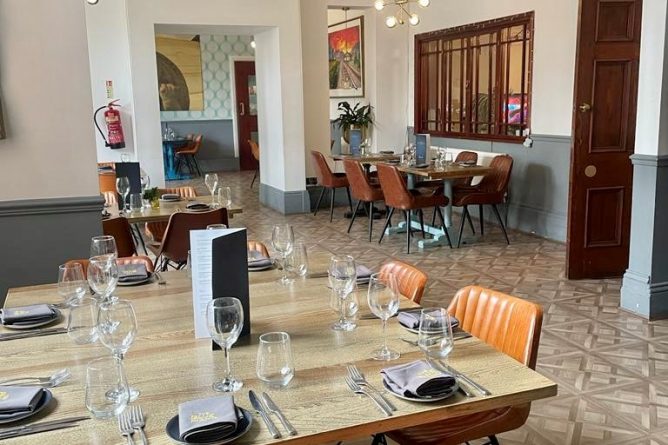 Blue Piano Bar dining space with modern decor, ideal for intimate events and meetings.