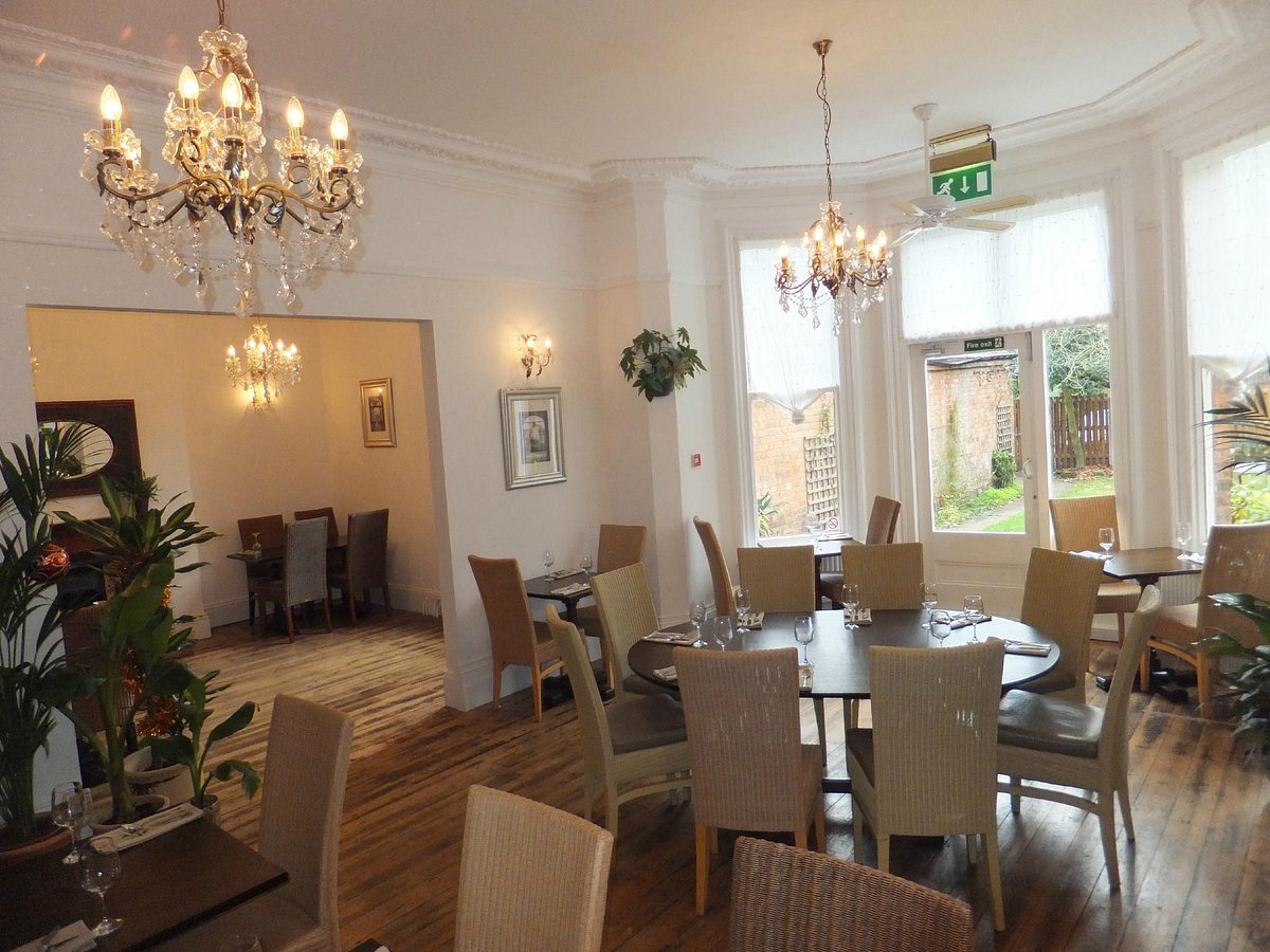 Blue Piano Bar dining space with chandeliers, ideal for intimate events and gatherings.
