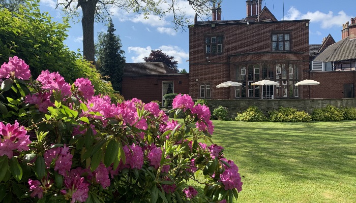 Terrace Room at Plough & Harrow Hotel, vibrant flowers, outdoor event venue.