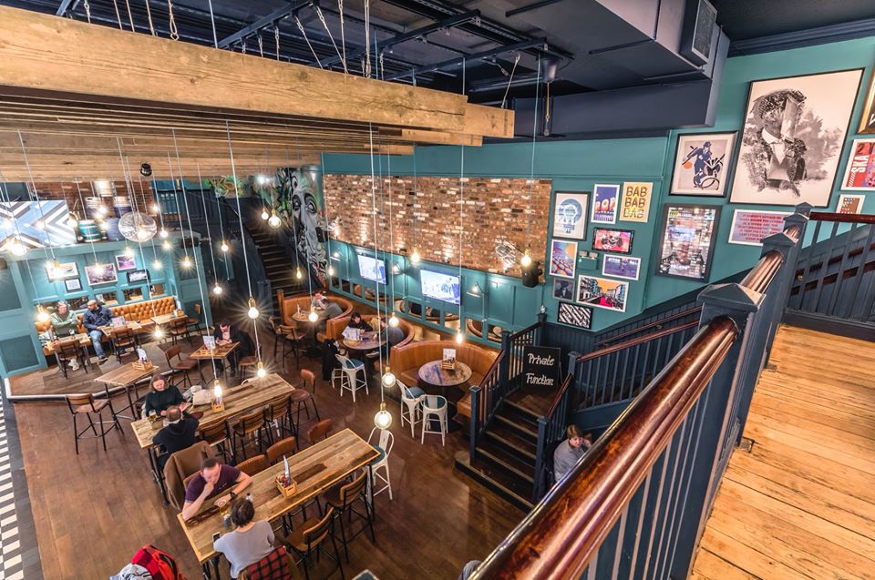 Vibrant multi-level venue with cozy booths for casual meetings and events.