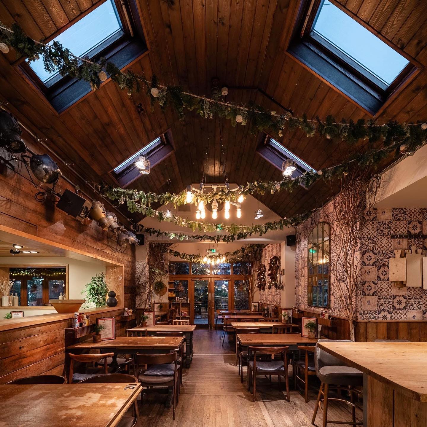 Charming rustic bar venue with greenery, perfect for intimate gatherings and events.