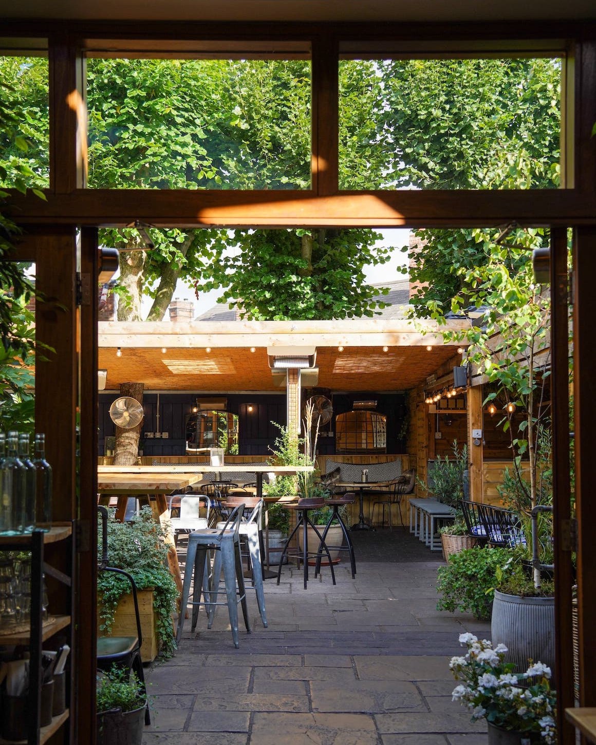 Outdoor event space at The Plough Harborne, featuring lush greenery and ample seating.