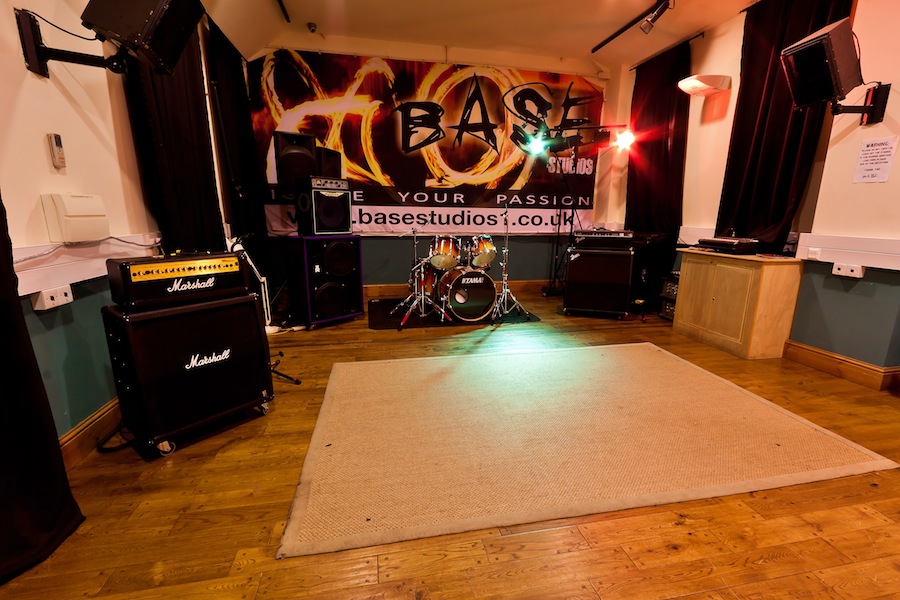 Rehearsal room with stage, sound gear for live performances and workshops at Base Studios.