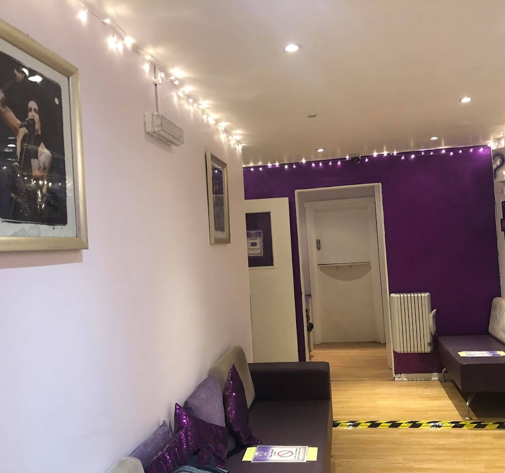 Stylish event space with purple accent wall, ideal for gatherings and meetings.