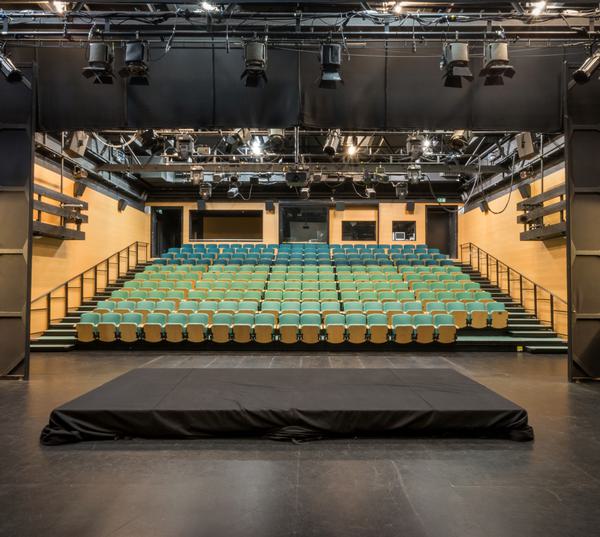 Bar area in Midlands Arts Centre with tiered seating for corporate events and performances.