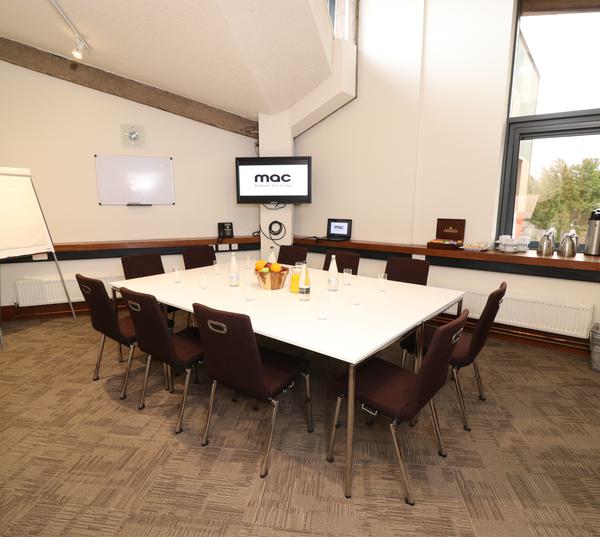 Meeting room at Midlands Arts Centre with large table, ideal for professional gatherings.