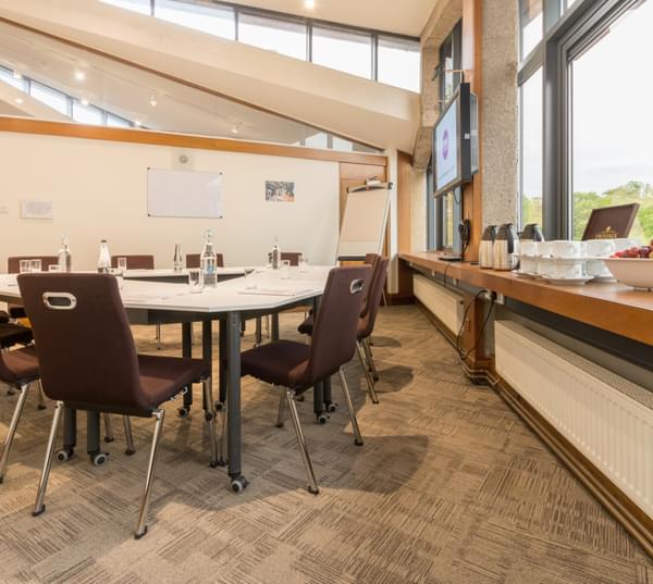 Meeting room with round table and natural light for productive workshops and meetings.