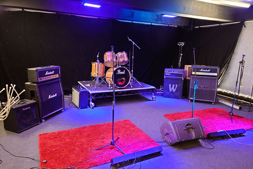 Control Room at Robannas Studios with drum set, ideal for music performances and rehearsals.