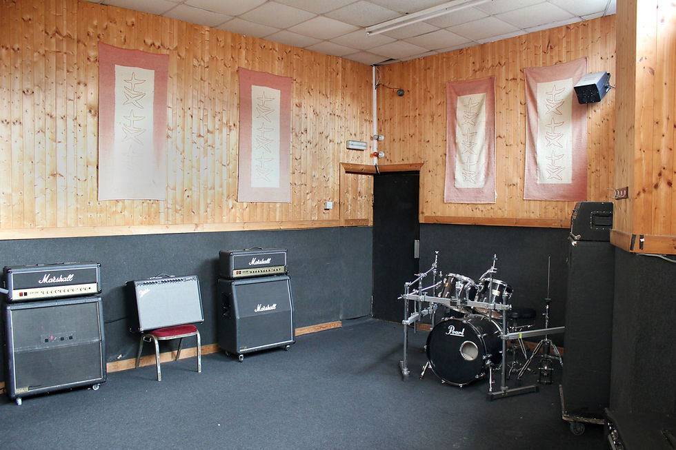 Recording studio at Robannas Studios with wooden walls, ideal for music events and workshops.