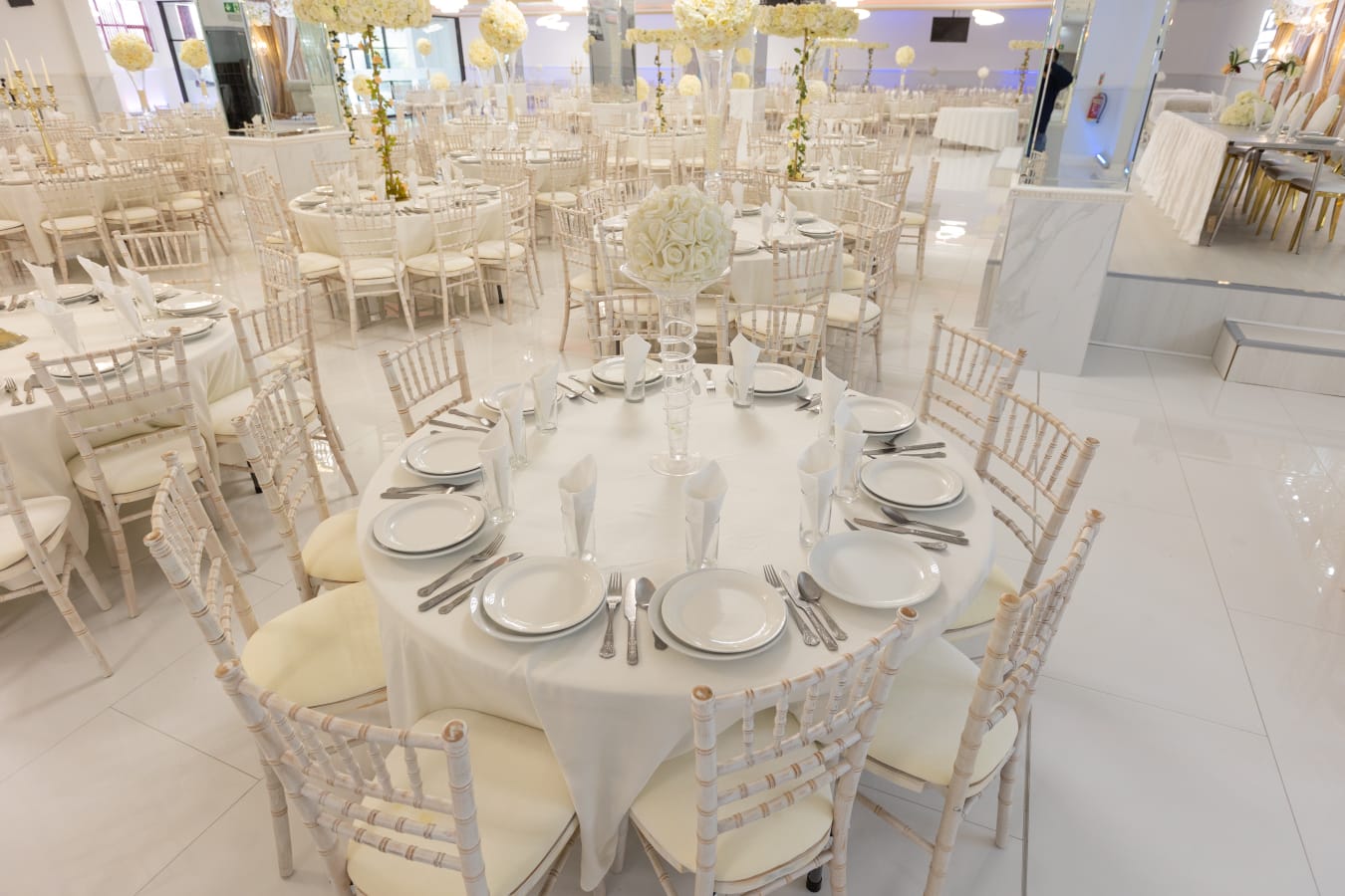 Elegant Mayfair Suite event space with round tables, perfect for weddings and formal gatherings.