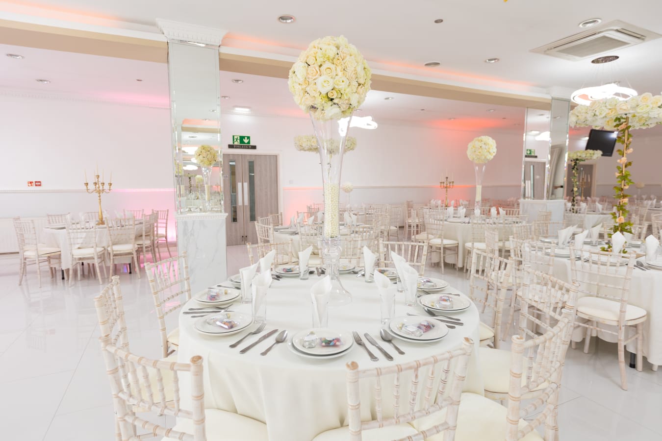 Elegant Mayfair Suite banquet hall with round tables, ideal for weddings and formal events.