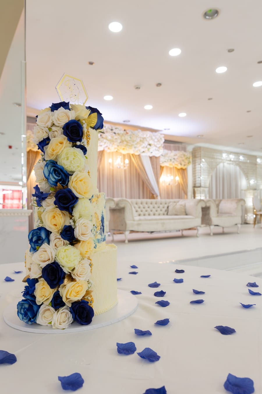 Elegant Mayfair Suite banquet hall with blue and cream floral cake for weddings.