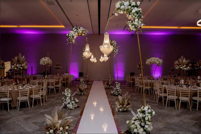 Elegant wedding venue at Old Farm Hotel with chandeliers and floral arrangements.