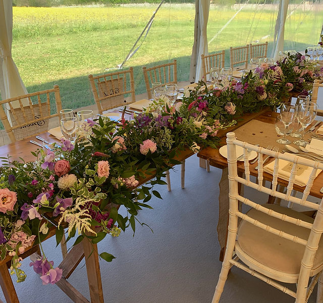 Elegant long table with floral centerpiece at Eyam Hall Weddings. Perfect for upscale events.