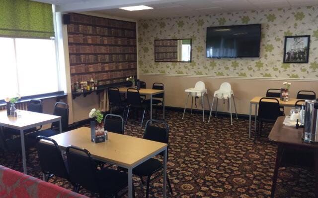 Function Room at Avenue Club: cozy meeting space with floral wallpaper for events.