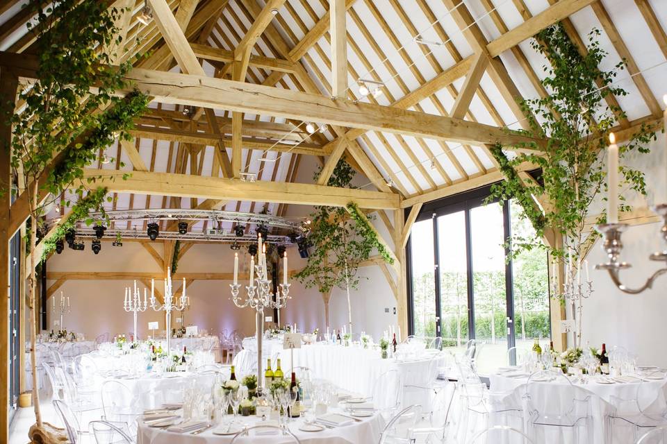 Elegant Redbrick Barn event space with rustic beams, perfect for weddings and upscale gatherings.
