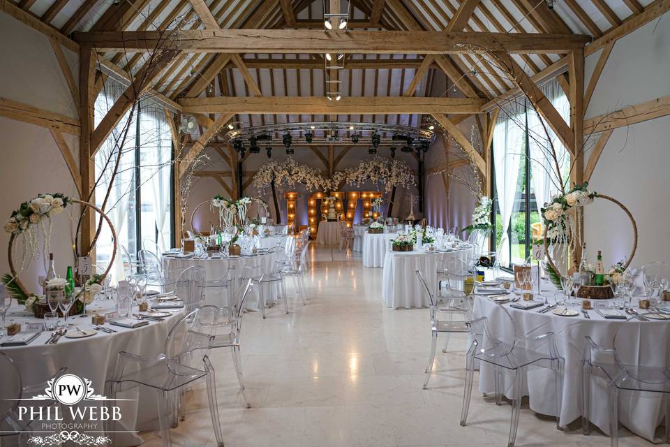 Elegant Redbrick Barn event space with round tables, perfect for weddings and corporate events.
