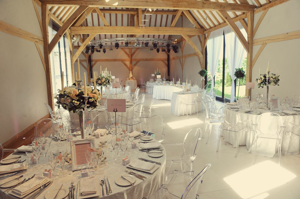 Elegant Redbrick Barn event space with round tables, ideal for weddings and gatherings.
