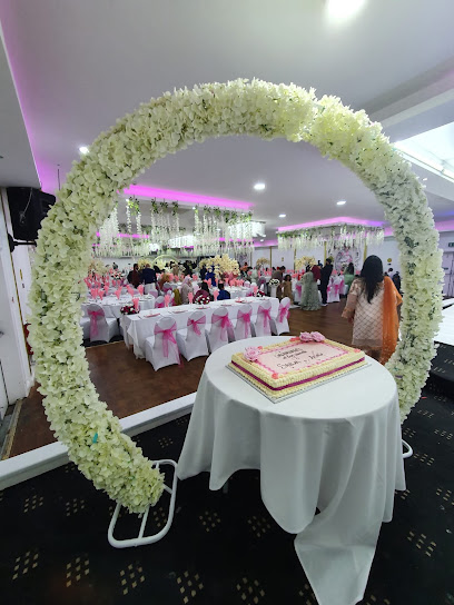 Elegant Banqueting Hall with floral arch, ideal for weddings and celebrations.