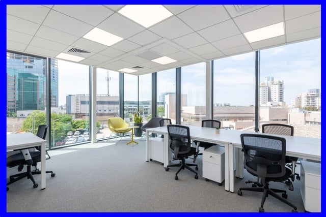 Modern office space with large windows, perfect for meetings and events.