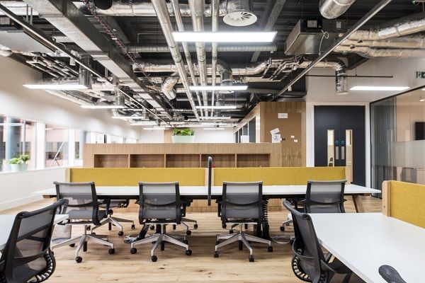 Modern open-concept office space with ergonomic seating for workshops and meetings.