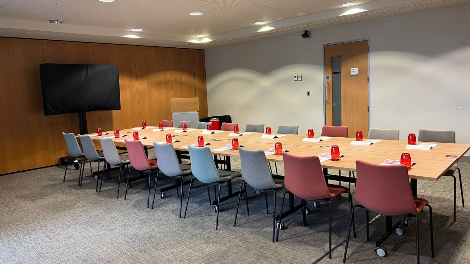 Locker Suite meeting room with colorful chairs, ideal for conferences and events.