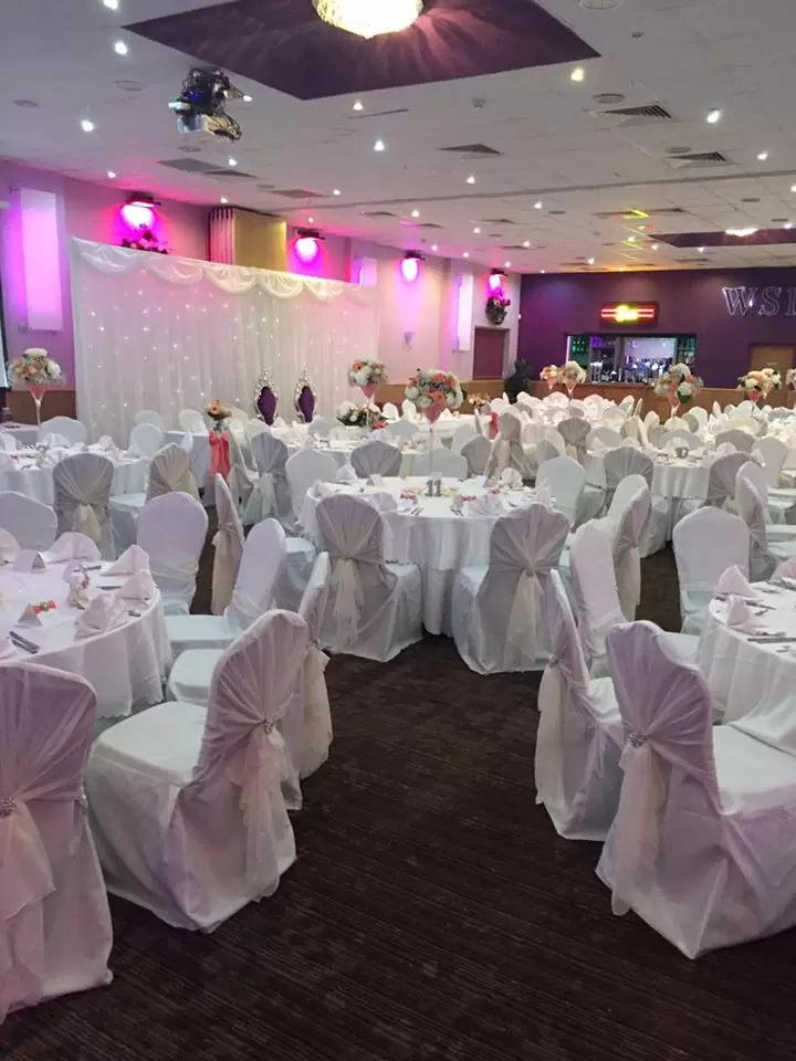 Elegant banquet hall with draped tables, perfect for weddings and formal events.