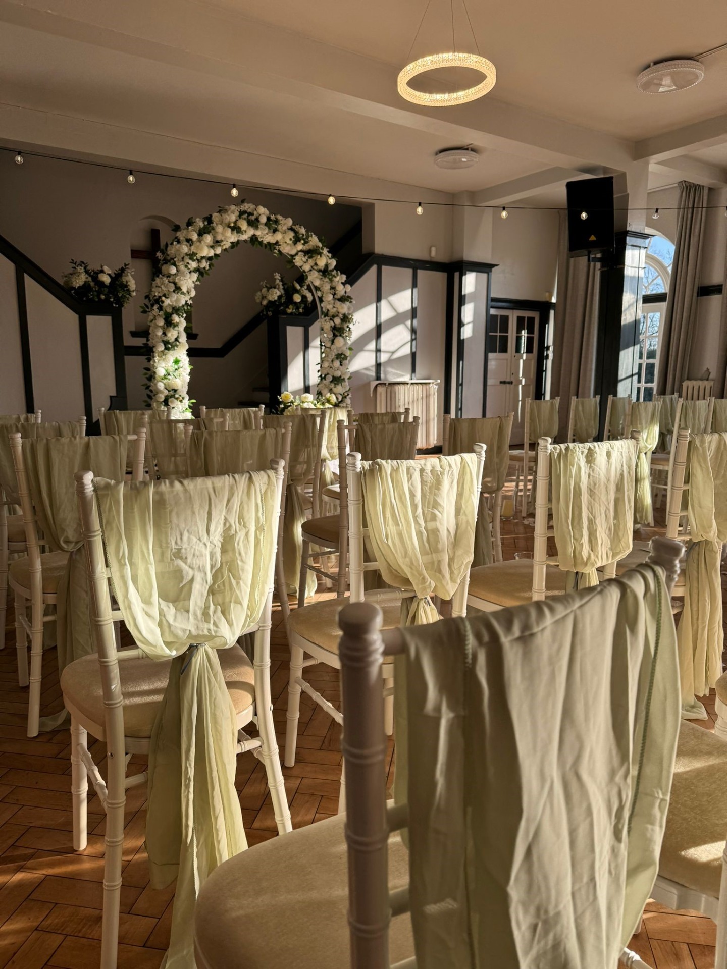 Elegant Terrace Room at Rowheath Pavilion with floral arch for weddings and events.