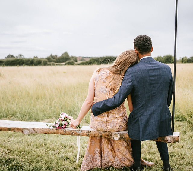 Couple seated in Wildflower Events Field, perfect for romantic outdoor weddings.