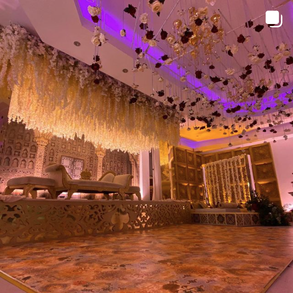 Elegant event space with floral backdrop, perfect for weddings and upscale gatherings.