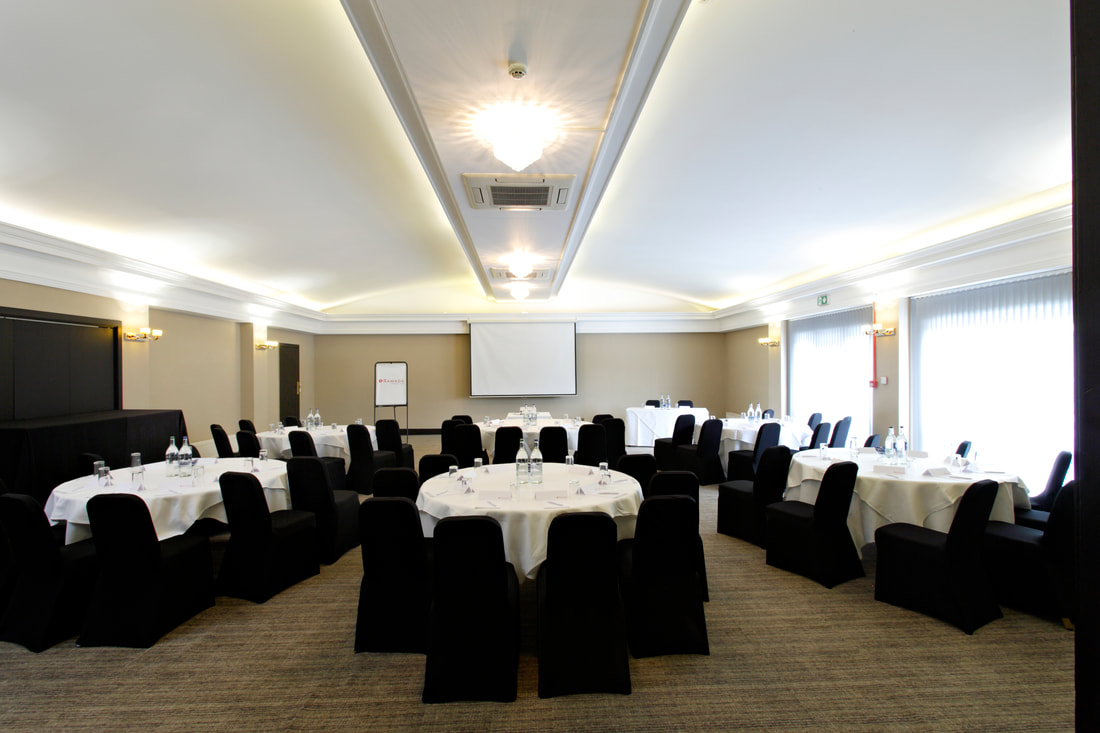 Presidential Suite meeting room with round tables, ideal for corporate events and workshops.