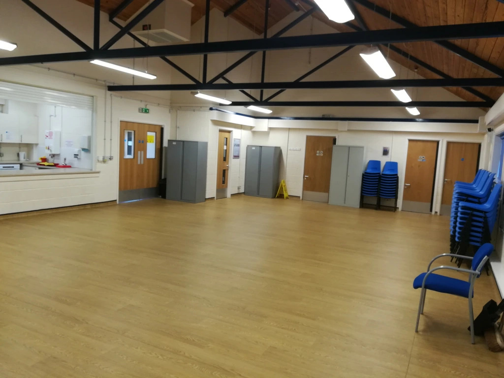 Versatile event space in The Oaks Community Hall with wooden flooring for meetings and workshops.
