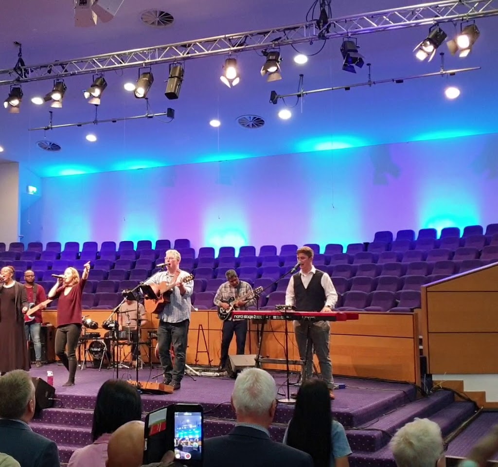Vibrant live performance in Bethel Convention Centre auditorium with engaging musicians.