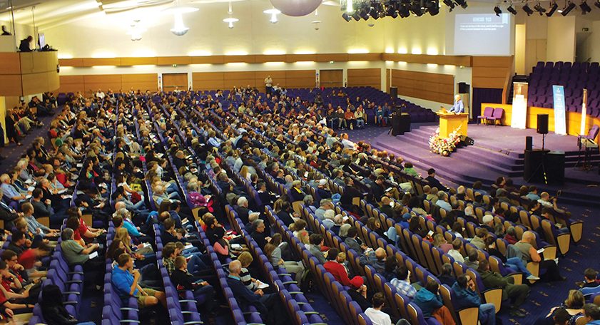 Main auditorium at Bethel Convention Centre with tiered seating for a conference event.