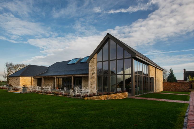 16th Century Barn at Blackwell Grange, modern event venue with glass facade for gatherings.