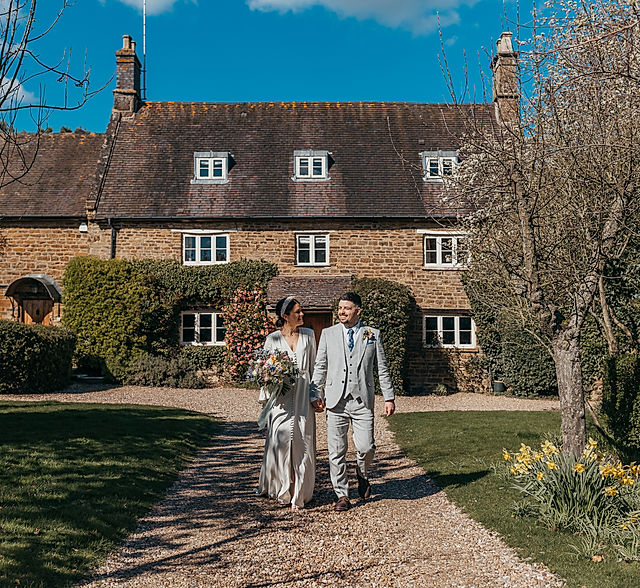 Catesby Barn at Dodmoor House, a charming wedding venue with lush greenery.
