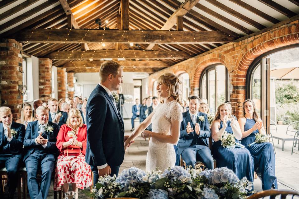Intimate wedding ceremony at Courtyard Barn with rustic charm and elegant floral arrangements.