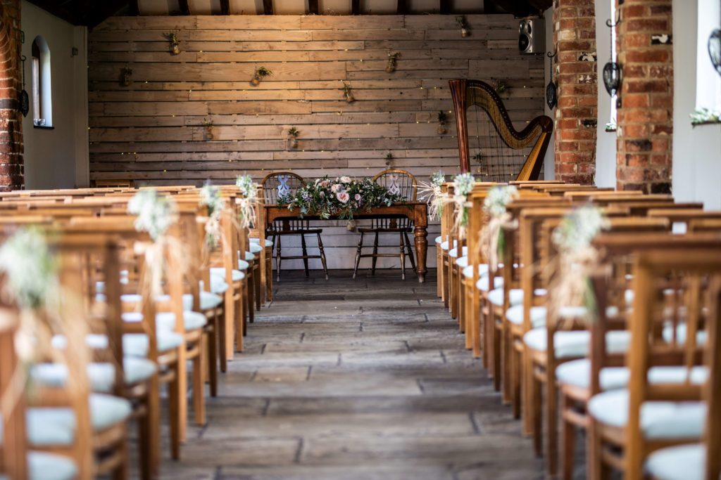 Courtyard Barn at Dodmoor House: elegant wedding venue with wooden decor and floral accents.