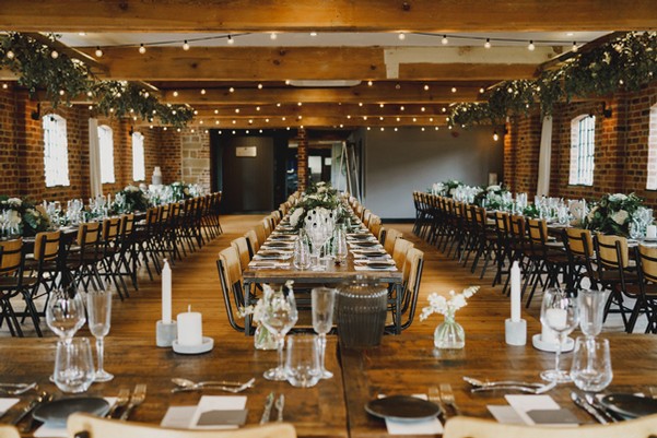 Elegant event space in Haarlem Mill with floral centerpieces, ideal for weddings and gatherings.