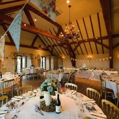 Panelled Hall in Deer Park: elegant wedding venue with warm beams and floral decor.