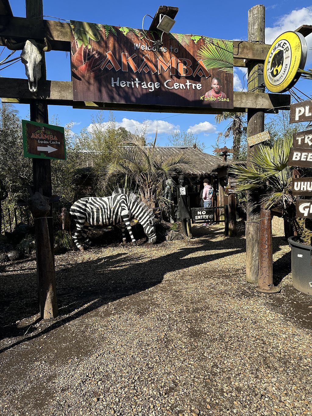 Outdoor restaurant entrance with zebra sculpture, perfect for themed events and gatherings.